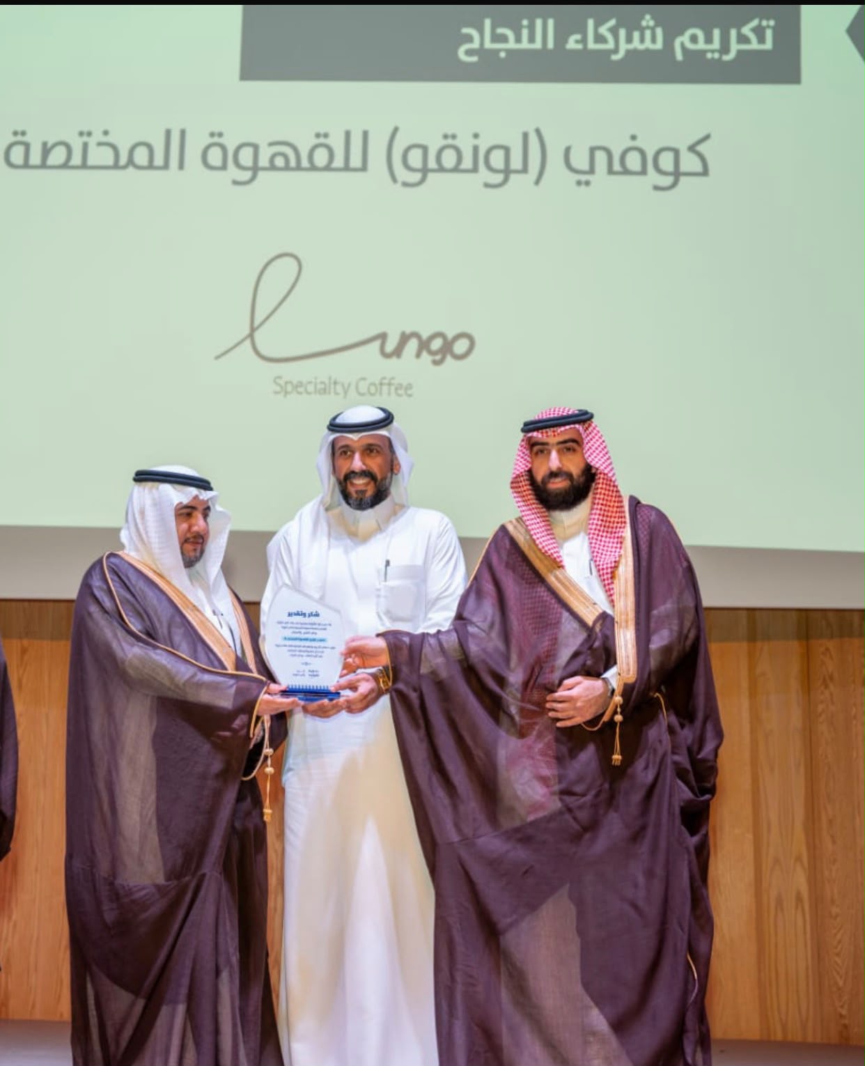 Lungo receiving an honour on stage from Ras Tanura officials