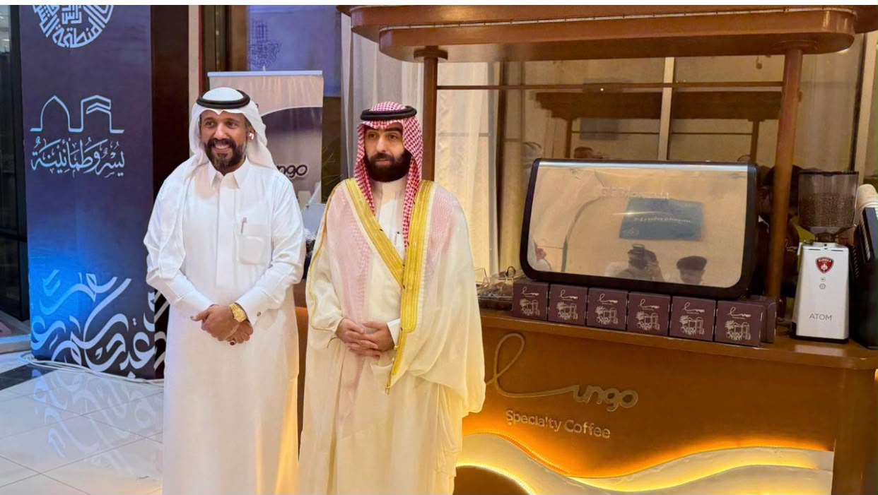 Officials beside the Lungo coffee station at a Ras Tanura ceremony